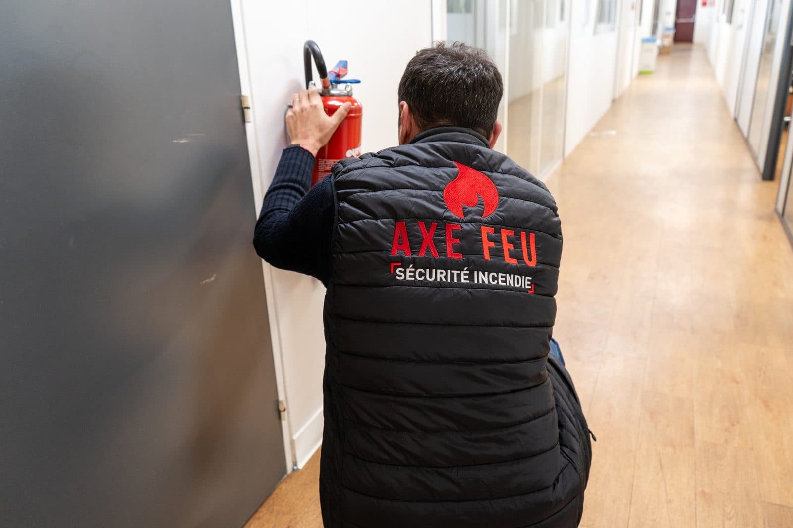 Maintenance d'extincteurs dans un couloir d'entreprise en Essonne